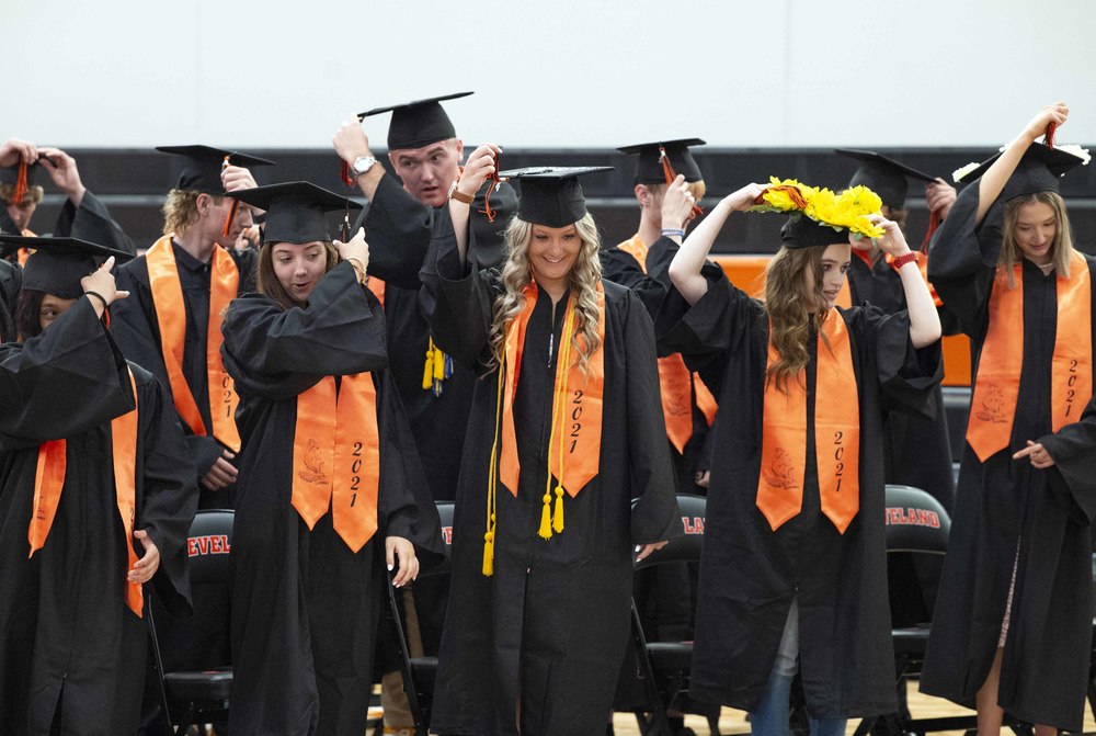 Seniors during graduation ceremony turn their tassels